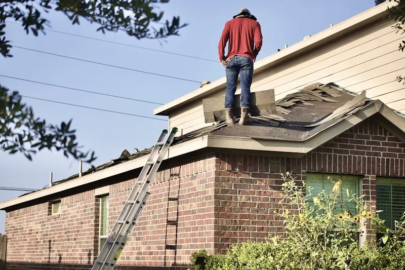 Professional roofer working on a residential roof in Tire Hill